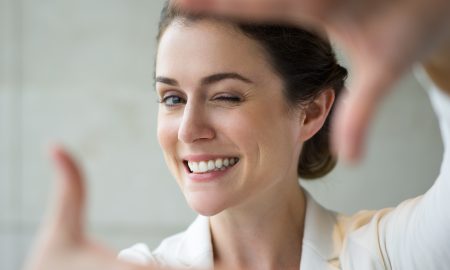 Closeup of Smiling Woman Making Frame Gesture