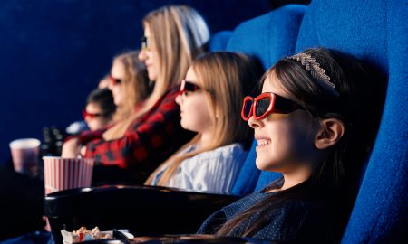 Little friends wearing 3d eyeglasses in cinema.
