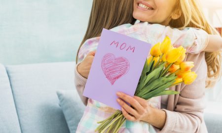mother-with-gifts-hugging-daughter-smiling