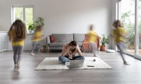 mulher-tentando-trabalhar-em-um-laptop-de-casa-enquanto-os-filhos-estao-correndo